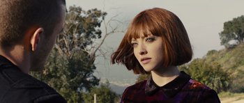 Movie still from “In Time” (2011), directed by Andrew Niccol – A person with short red hair; Close Up shot, Low angle