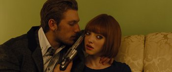 Movie still from “In Time” (2011), directed by Andrew Niccol – A man and a woman are holding a gun; Close Up shot, Low angle