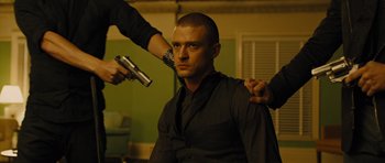 Movie still from “In Time” (2011), directed by Andrew Niccol – A man getting his hair done; Medium shot, Low angle