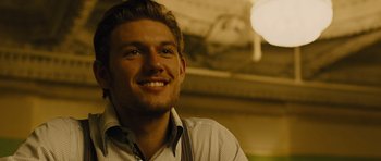 Movie still from “In Time” (2011), directed by Andrew Niccol – A person smiling for the camera; Close Up shot, Over the shoulder angle