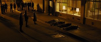 Movie still from “In Time” (2011), directed by Andrew Niccol – A group of people standing on the side of the street; Extreme Wide shot, High angle