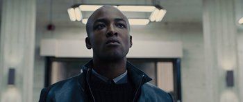 Movie still from “In Time” (2011), directed by Andrew Niccol – A man with a bald head looking up at the ceiling; Close Up shot, Low angle