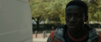 Movie still from “Imperium” (2016), directed by Daniel Ragussis – A young man wearing a jacket and a vest; Close Up shot, Over the shoulder angle