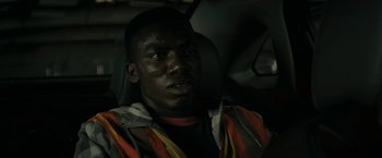 Movie still from “Imperium” (2016), directed by Daniel Ragussis – A man in a car wearing a safety vest; Close Up shot, Low angle