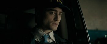Movie still from “Imperium” (2016), directed by Daniel Ragussis – A person wearing a hat; Close Up shot, Over the shoulder angle