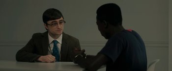 Movie still from “Imperium” (2016), directed by Daniel Ragussis – Two men sitting at a table talking to each other; Medium shot, Over the shoulder angle