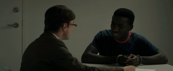 Movie still from “Imperium” (2016), directed by Daniel Ragussis – Two men sitting at a table talking to each other; Medium shot, Over the shoulder angle