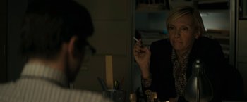 Movie still from “Imperium” (2016), directed by Daniel Ragussis – A woman smoking a cigarette in front of a mirror; Close Up shot, Over the shoulder angle