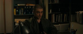 Movie still from “Imperium” (2016), directed by Daniel Ragussis – A man sitting in front of a book shelf; Close Up shot, Over the shoulder angle
