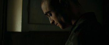 Movie still from “Imperium” (2016), directed by Daniel Ragussis – A man's face in the dark; Close Up shot, Over the shoulder angle