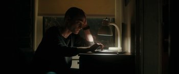 Movie still from “Imperium” (2016), directed by Daniel Ragussis – A man sitting in front of a computer at a desk; Medium shot, Low angle