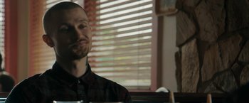 Movie still from “Imperium” (2016), directed by Daniel Ragussis – A person sitting at a table; Close Up shot, Over the shoulder angle