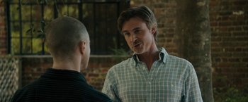 Movie still from “Imperium” (2016), directed by Daniel Ragussis – A man talking to another man in front of a brick wall; Close Up shot, Over the shoulder angle