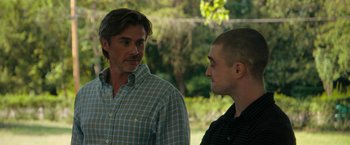 Movie still from “Imperium” (2016), directed by Daniel Ragussis – Two men standing next to each other in a park; Close Up shot, Over the shoulder angle