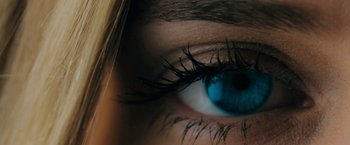 Movie still from “Imperium” (2016), directed by Daniel Ragussis – A woman's blue eye with long lashes; Extreme Close Up shot, Overhead angle