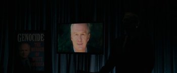 Movie still from “Imperium” (2016), directed by Daniel Ragussis – A person is standing in front of a television screen; Close Up shot, Over the shoulder angle