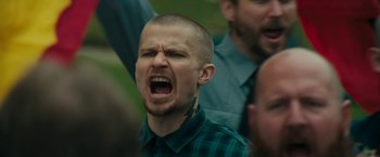 Movie still from “Imperium” (2016), directed by Daniel Ragussis – A man with a shaved head is screaming; Close Up shot, Low angle
