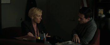Movie still from “Imperium” (2016), directed by Daniel Ragussis – A woman sitting at a table in front of a man; Medium shot, Over the shoulder angle