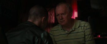 Movie still from “Imperium” (2016), directed by Daniel Ragussis – Two men are talking in a dark room; Close Up shot, Over the shoulder angle