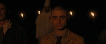 Movie still from “Imperium” (2016), directed by Daniel Ragussis – A man in a brown jacket and a man in a white robe; Close Up shot, Over the shoulder angle