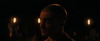 Movie still from “Imperium” (2016), directed by Daniel Ragussis – A person's face in the dark; Close Up shot, Over the shoulder angle