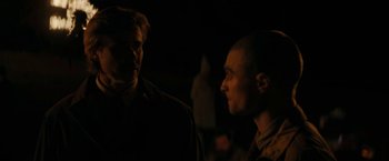 Movie still from “Imperium” (2016), directed by Daniel Ragussis – Two men standing next to each other in the dark; Close Up shot, Over the shoulder angle