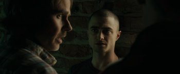 Movie still from “Imperium” (2016), directed by Daniel Ragussis – Two men standing next to each other in front of a brick wall; Close Up shot, Over the shoulder angle