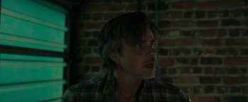 Movie still from “Imperium” (2016), directed by Daniel Ragussis – A person wearing a plaid shirt; Close Up shot, Low angle