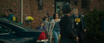 Movie still from “Imperium” (2016), directed by Daniel Ragussis – A group of people walking down a street; Wide shot, Over the shoulder angle