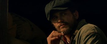 Movie still from “In Dubious Battle” (2016), directed by James Franco – A person smoking a cigarette; Close Up shot, Over the shoulder angle
