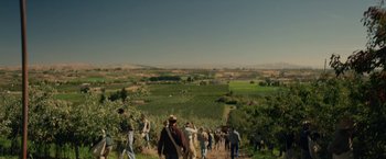 Movie still from “In Dubious Battle” (2016), directed by James Franco – A group of people walking on a dirt path; Extreme Wide shot, High angle