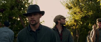 Movie still from “In Dubious Battle” (2016), directed by James Franco – A couple of men standing next to each other in a field; Close Up shot, Low angle