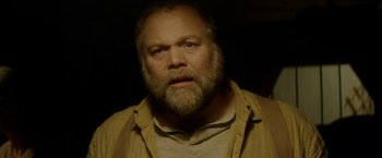 Movie still from “In Dubious Battle” (2016), directed by James Franco – A man with a beard is looking at the camera; Close Up shot, Low angle