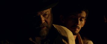 Movie still from “In Dubious Battle” (2016), directed by James Franco – A man with a beard wearing a hat and holding a cigarette; Close Up shot, Over the shoulder angle