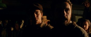 Movie still from “In Dubious Battle” (2016), directed by James Franco – A man in a hat is looking at the camera; Close Up shot, Over the shoulder angle