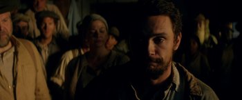 Movie still from “In Dubious Battle” (2016), directed by James Franco – A man and a woman in a dark room; Close Up shot, Over the shoulder angle