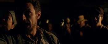 Movie still from “In Dubious Battle” (2016), directed by James Franco – A person in a dark room; Close Up shot, Over the shoulder angle