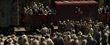 Movie still from “In Dubious Battle” (2016), directed by James Franco – A group of people standing next to a train; Extreme Wide shot, High angle