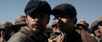 Movie still from “In Dubious Battle” (2016), directed by James Franco – A group of men standing next to each other; Close Up shot, Over the shoulder angle