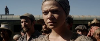 Movie still from “In Dubious Battle” (2016), directed by James Franco – A person wearing a hat; Close Up shot, Over the shoulder angle