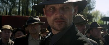 Movie still from “In Dubious Battle” (2016), directed by James Franco – A person wearing a hat; Close Up shot, Low angle