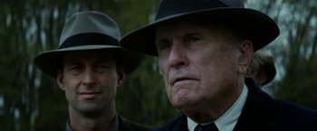 Movie still from “In Dubious Battle” (2016), directed by James Franco – Two men in suits and hats are standing next to each other; Close Up shot, Low angle