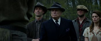 Movie still from “In Dubious Battle” (2016), directed by James Franco – Two men in suits and hats standing next to each other; Medium shot, Low angle