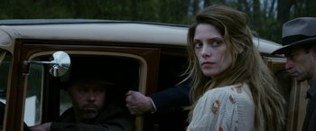 Movie still from “In Dubious Battle” (2016), directed by James Franco – A man and a woman sitting in the back of a car; Close Up shot, Over the shoulder angle