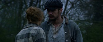 Movie still from “In Dubious Battle” (2016), directed by James Franco – A man and a woman standing next to each other in the woods; Close Up shot, Over the shoulder angle