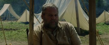 Movie still from “In Dubious Battle” (2016), directed by James Franco – A man with a gray beard is sitting in a tent; Close Up shot, Low angle
