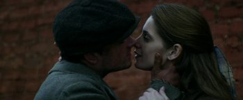 Movie still from “In Dubious Battle” (2016), directed by James Franco – A man and a woman are kissing each other; Close Up shot, Over the shoulder angle