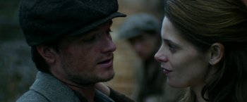 Movie still from “In Dubious Battle” (2016), directed by James Franco – A man and a woman face to face in front of a brick wall; Close Up shot, Low angle