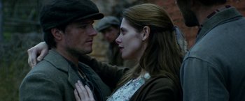 Movie still from “In Dubious Battle” (2016), directed by James Franco – A man and a woman standing next to each other; Close Up shot, Over the shoulder angle