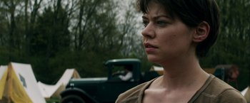 Movie still from “In Dubious Battle” (2016), directed by James Franco – A person with a car in the background; Close Up shot, Over the shoulder angle